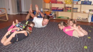 Mr. Chase teaching a the kids a new yoga pose